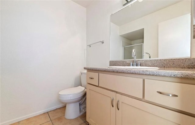 bathroom with walk in shower, vanity, tile patterned flooring, and toilet