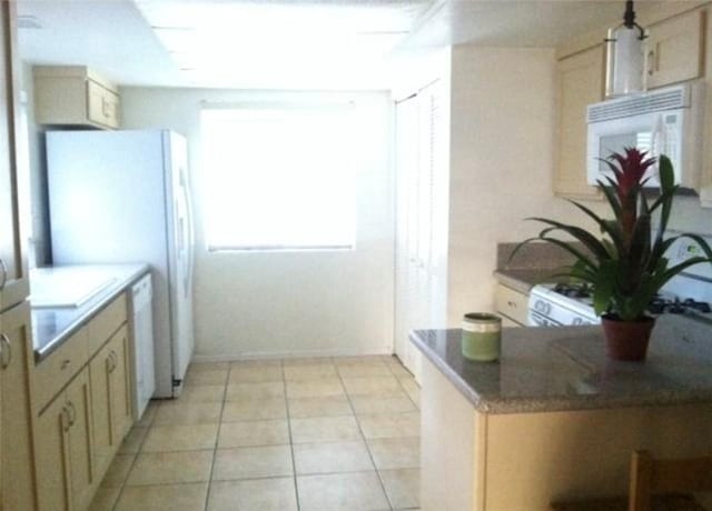 kitchen featuring white appliances and kitchen peninsula