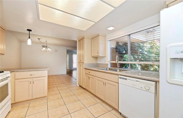 kitchen with pendant lighting, white appliances, sink, cream cabinets, and a notable chandelier