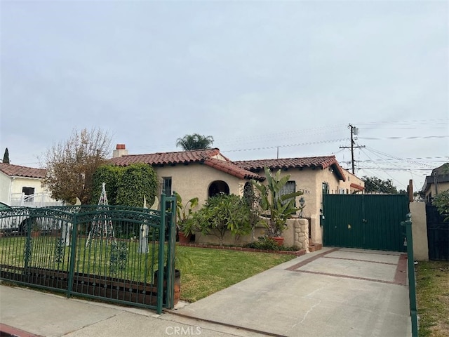 mediterranean / spanish-style house with a front yard