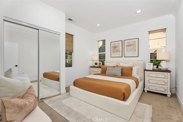 bedroom featuring ornamental molding and a closet