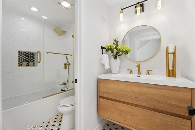 full bathroom featuring tile patterned flooring, shower / bath combination with glass door, vanity, and toilet