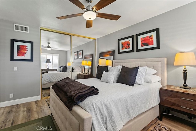 bedroom featuring ceiling fan, a closet, and hardwood / wood-style flooring