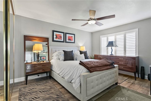 bedroom with hardwood / wood-style floors and ceiling fan