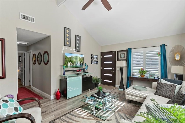 living room featuring beamed ceiling, light hardwood / wood-style floors, high vaulted ceiling, and ceiling fan