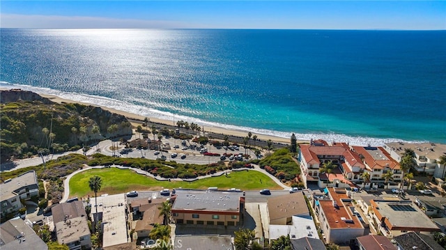 birds eye view of property featuring a residential view, a water view, and a beach view