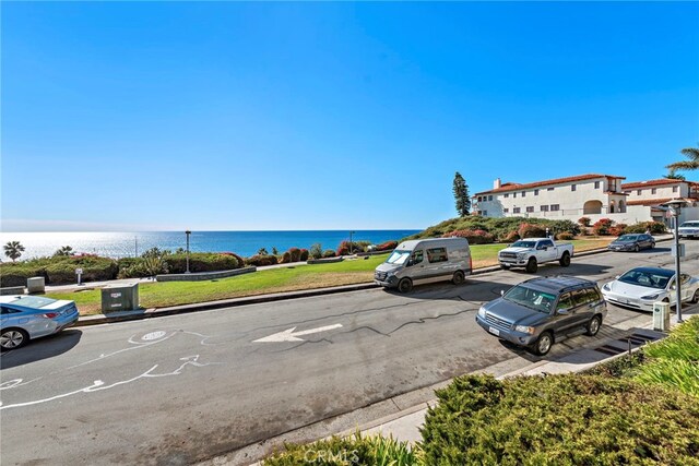 view of vehicle parking with a water view