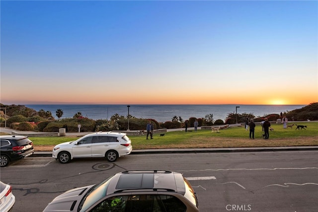 view of parking with a water view