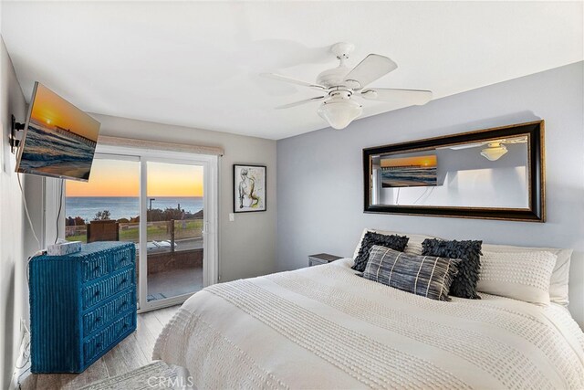 bedroom with access to exterior, a ceiling fan, and wood finished floors