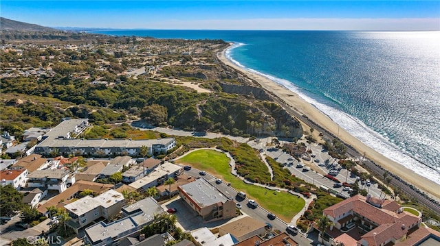 birds eye view of property featuring a view of the beach and a water view