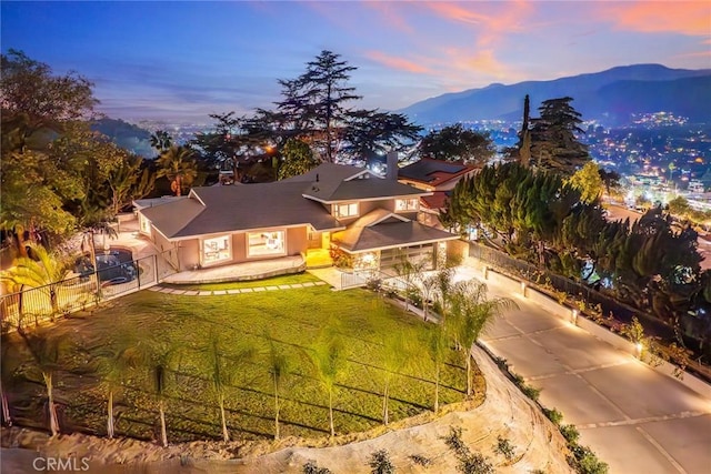 aerial view at dusk featuring a mountain view