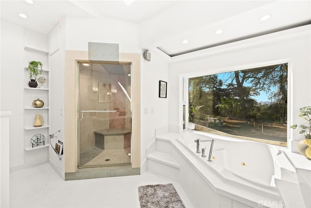 bathroom featuring independent shower and bath and built in shelves