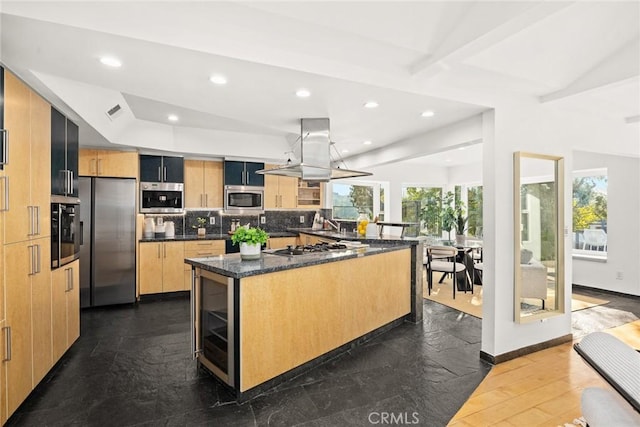 kitchen with stainless steel appliances, a center island, island range hood, decorative backsplash, and dark stone counters