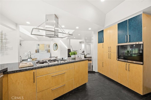 kitchen with white gas stovetop, dark stone counters, and oven