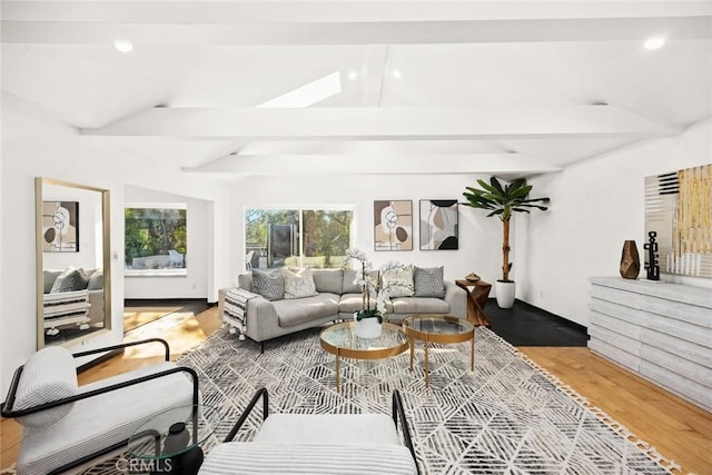 living room featuring hardwood / wood-style flooring and lofted ceiling with beams