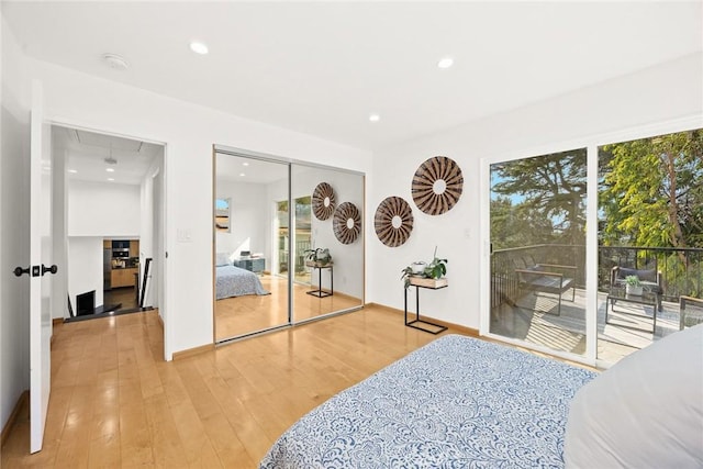 bedroom with access to outside and light wood-type flooring