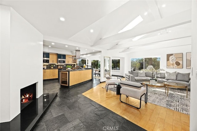 living room featuring dark hardwood / wood-style flooring, vaulted ceiling with beams, and beverage cooler