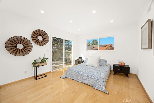 bedroom featuring hardwood / wood-style flooring and access to exterior