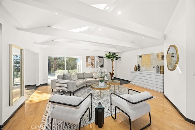 living room with vaulted ceiling with beams and light wood-type flooring