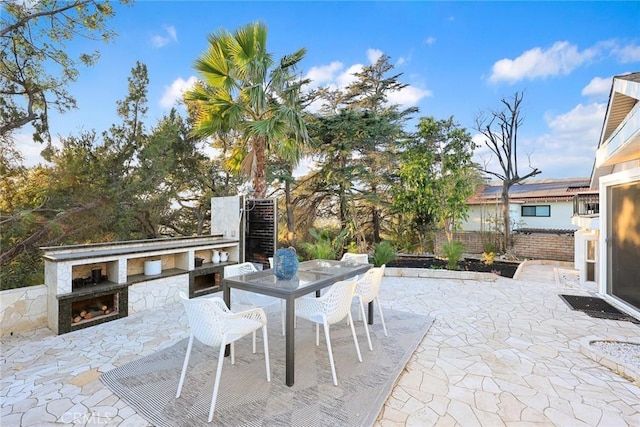 view of patio with an outdoor fireplace