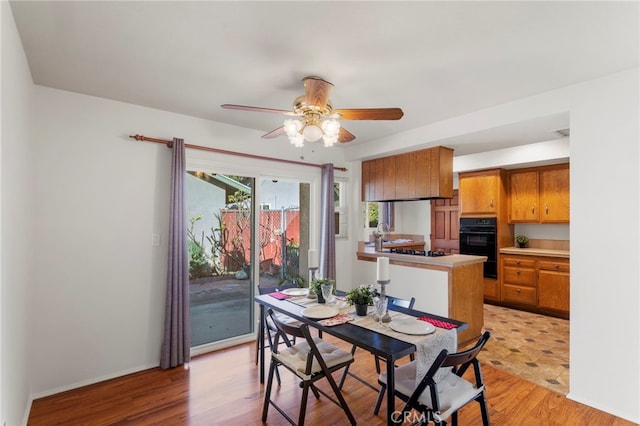 dining area featuring ceiling fan and light hardwood / wood-style flooring