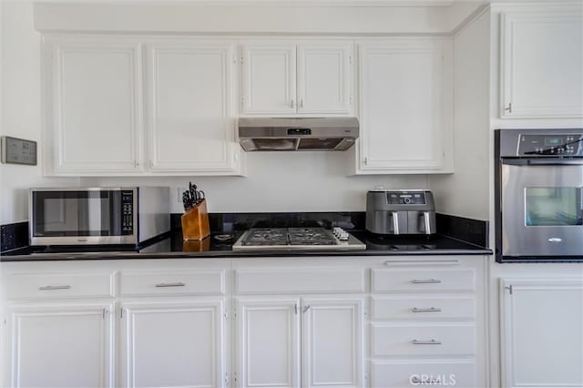 kitchen with stainless steel appliances and white cabinets