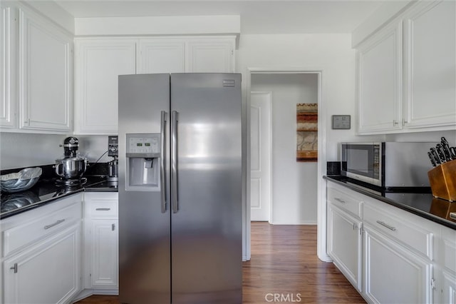 kitchen featuring stainless steel refrigerator with ice dispenser, white cabinets, and dark hardwood / wood-style flooring