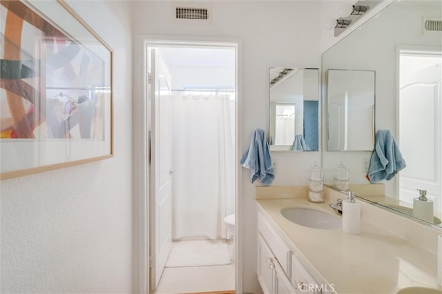 bathroom featuring vanity, a healthy amount of sunlight, and a shower with shower curtain