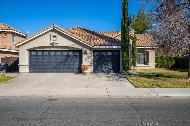 view of front of home with a garage and a front lawn