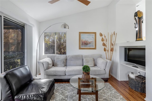 living room featuring hardwood / wood-style floors and ceiling fan