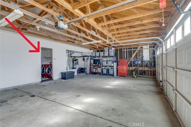 garage featuring washing machine and clothes dryer and a garage door opener