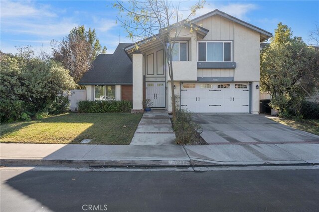 view of front of home featuring a garage and a front lawn