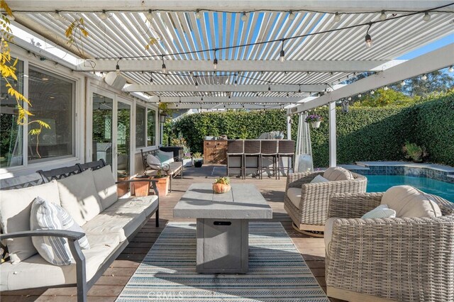 view of patio featuring outdoor lounge area, a bar, and a pergola