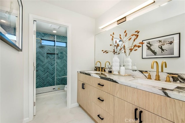 bathroom with tile patterned floors, vanity, toilet, and a shower with shower door