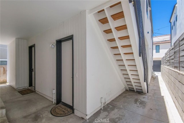 staircase featuring concrete floors