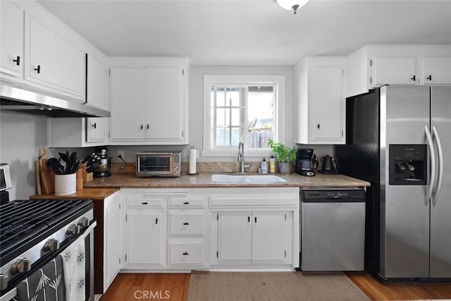 kitchen featuring white cabinets, sink, light wood-type flooring, and stainless steel appliances