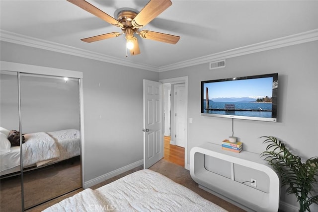 bedroom featuring a closet, ceiling fan, and crown molding