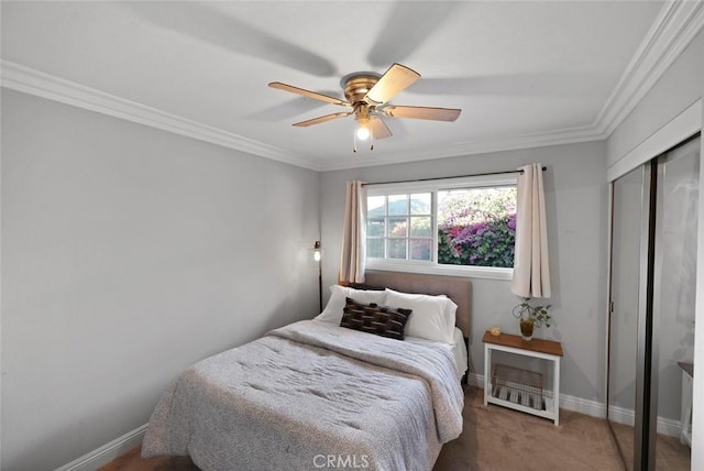 bedroom featuring ceiling fan, a closet, carpet, and ornamental molding