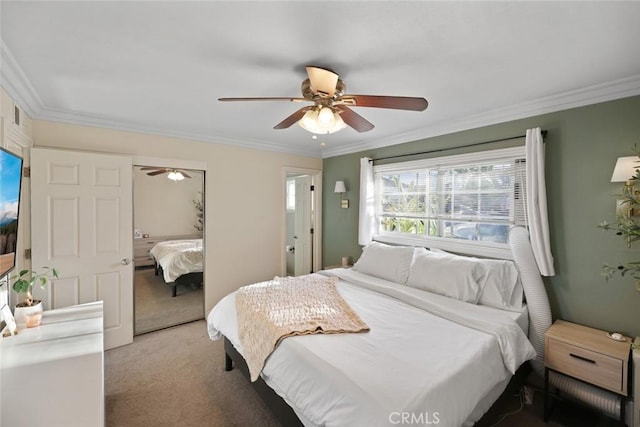 carpeted bedroom with ceiling fan and ornamental molding