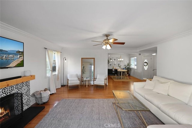 living room featuring dark hardwood / wood-style floors, ceiling fan, and plenty of natural light