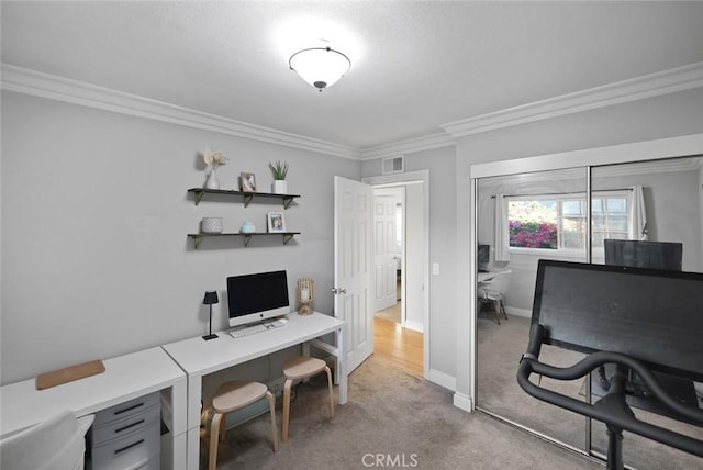 carpeted home office with crown molding