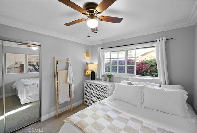 carpeted bedroom with ceiling fan and crown molding