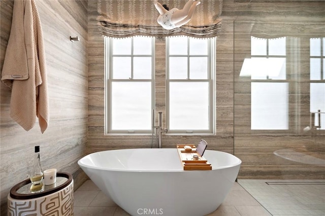 bathroom featuring a washtub and tile patterned flooring