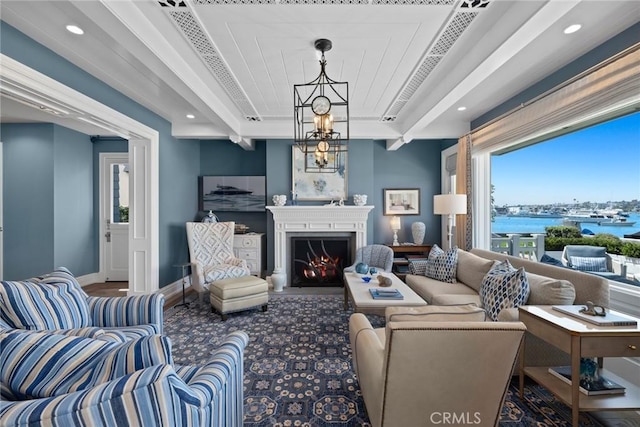 living room with a water view and an inviting chandelier