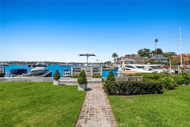 view of dock featuring a water view and a yard