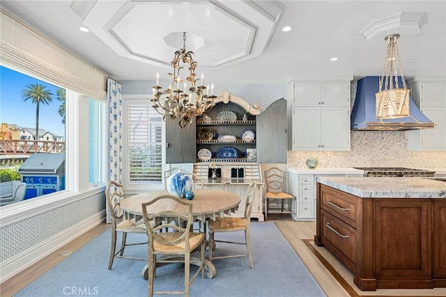 dining room featuring a notable chandelier and light hardwood / wood-style flooring