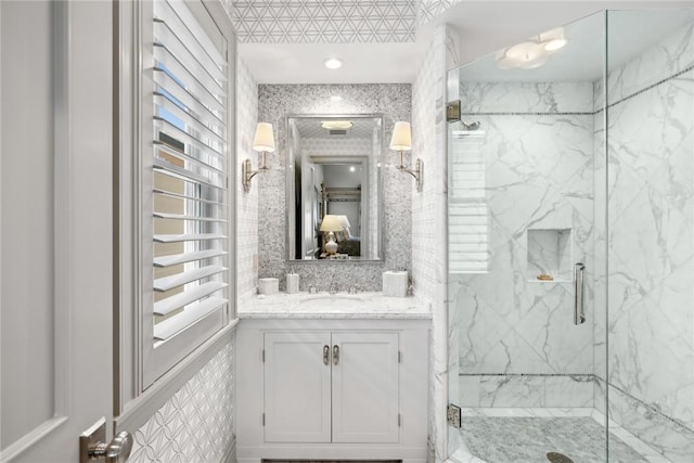 bathroom with vanity and a shower with shower door