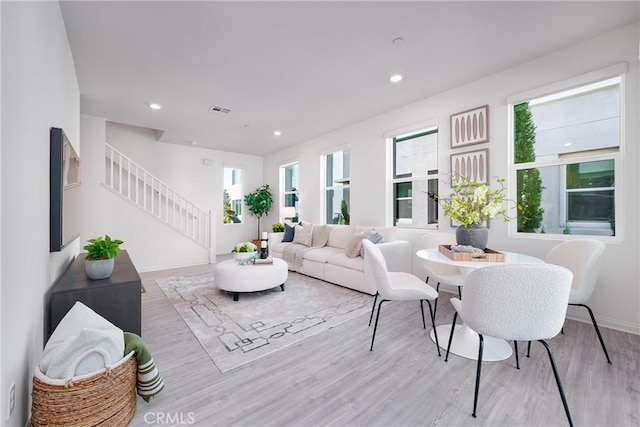 living room featuring light hardwood / wood-style floors and a wealth of natural light