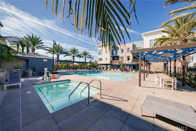 view of pool featuring a pergola, a hot tub, and a patio area