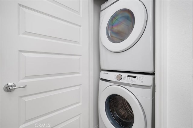 laundry room featuring stacked washer / dryer